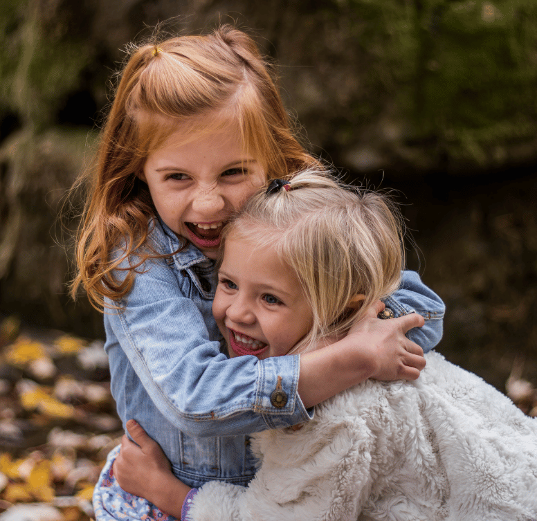 two little girls cuddling 
